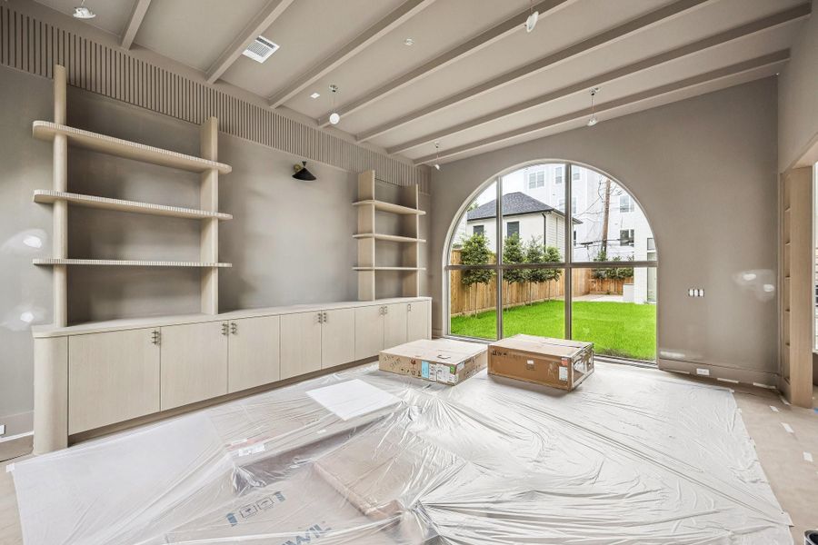Another view of the Library with incredible trim work and matching windows, that look out onto the large courtyard. Construction as of June 1st, 2026.