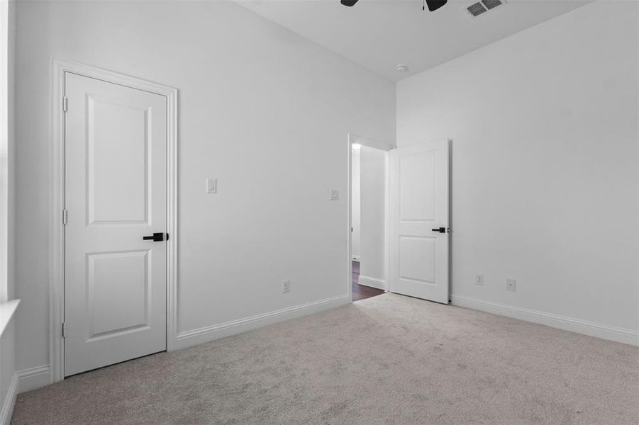 Unfurnished bedroom featuring carpet and ceiling fan Unfurnished bedroom featuring carpet and ceiling fan