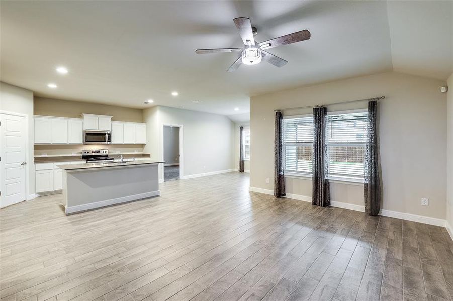 Kitchen featuring white cabinetry, open floor plan, healthy amount of natural light, stainless steel appliances, and recessed lighting Kitchen featuring white cabinetry, open floor plan, healthy amount of natural light, stainless steel appliances, and recessed lighting
