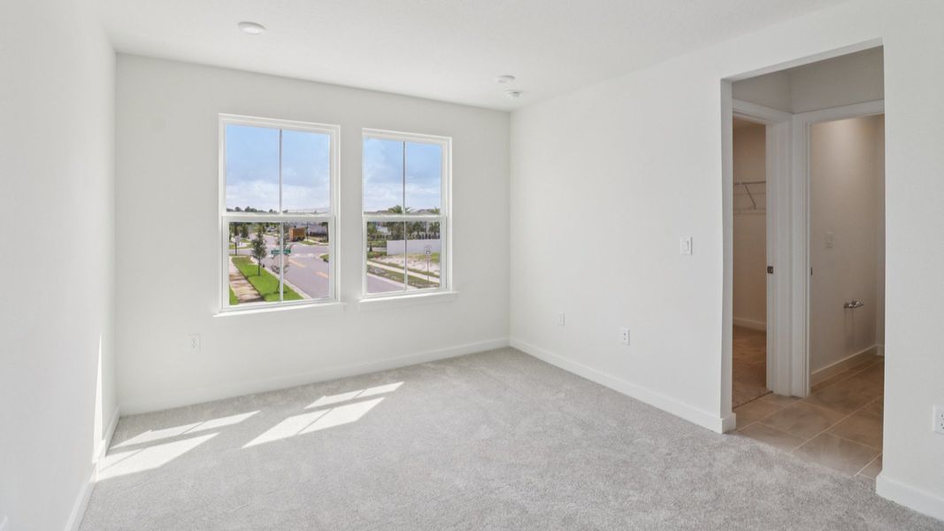 Primary Suite with en suite bath with dual sinks in the Monterey End Townhome by DRB Homes - Cyrene at Harmony in St Cloud FL