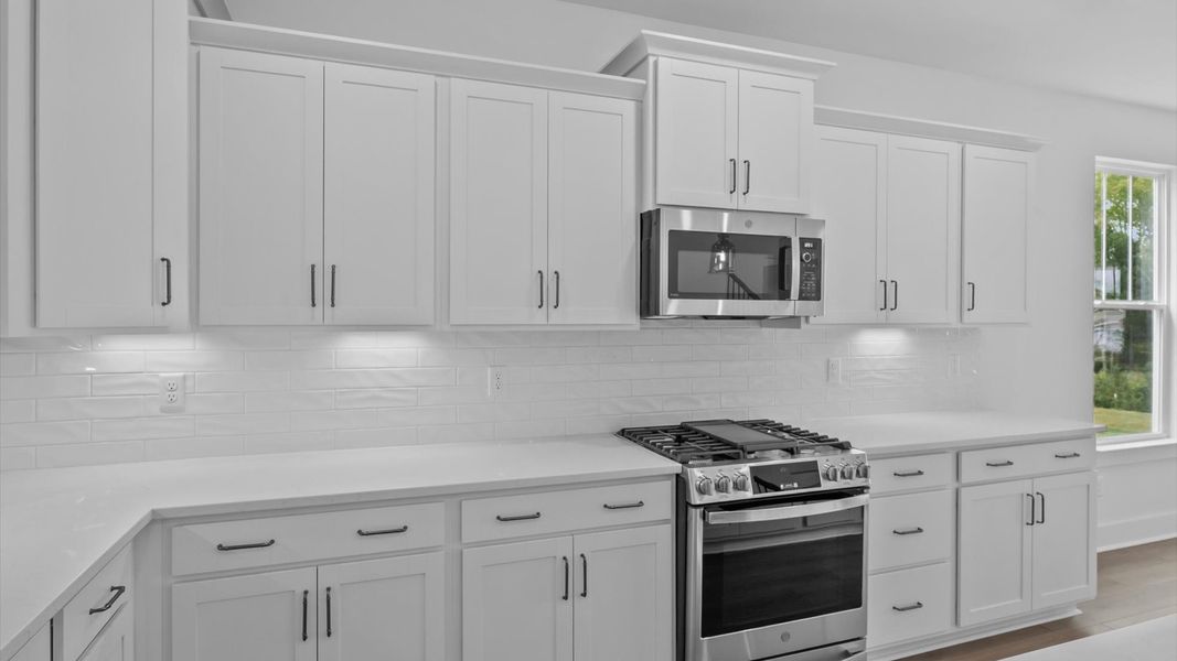 First-rate kitchen with functional layout, designer pendant lighting, and a large center island First-rate kitchen with functional layout, designer pendant lighting, and a large center island