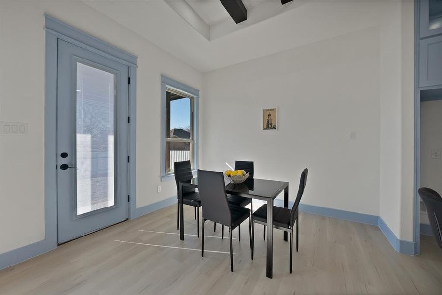 Dining space with light wood finished floors and baseboards