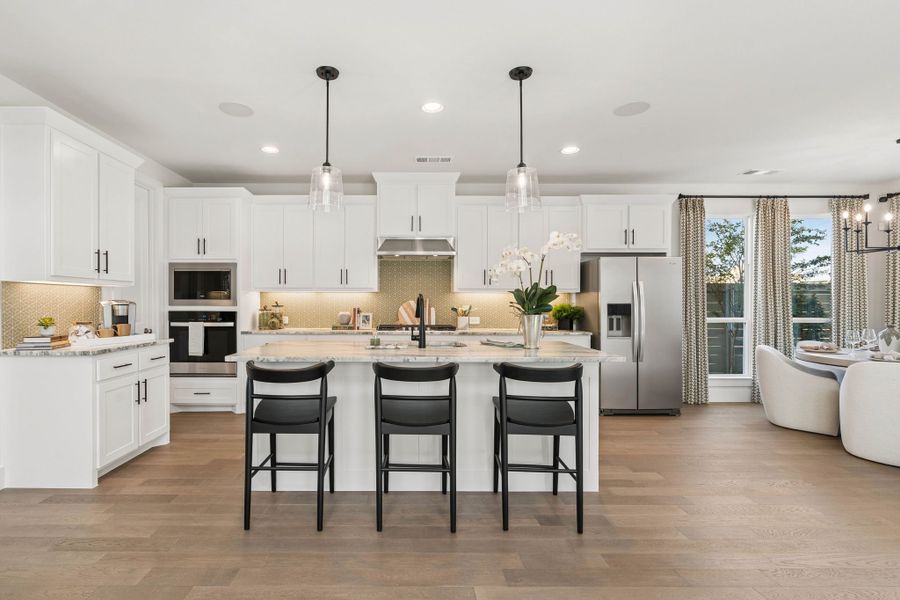 Gourmet Kitchen with White Cabinetry in American Legend Homes Model - Representative Photo of Plan 1462