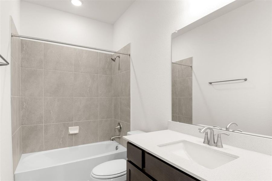 Full bathroom featuring toilet, vanity, and shower / bathing tub combination