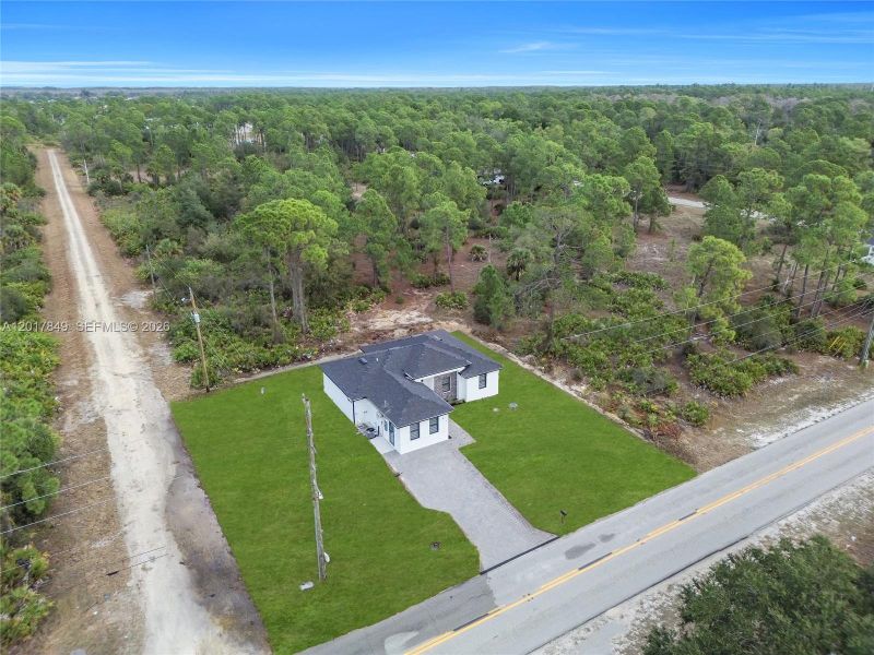 Front exterior of a new home in , Lehigh Acres, FL, highlighting curb appeal (Image 23).