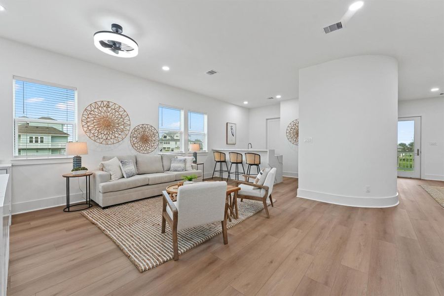 View from the kitchen towards the wet bar and laundry room, with a half bath. View from the kitchen towards the wet bar and laundry room, with a half bath.