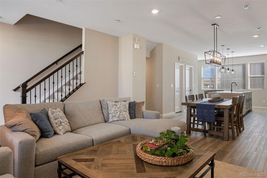 Another view of the living room showcasing its open flow to the dining area and kitchen.