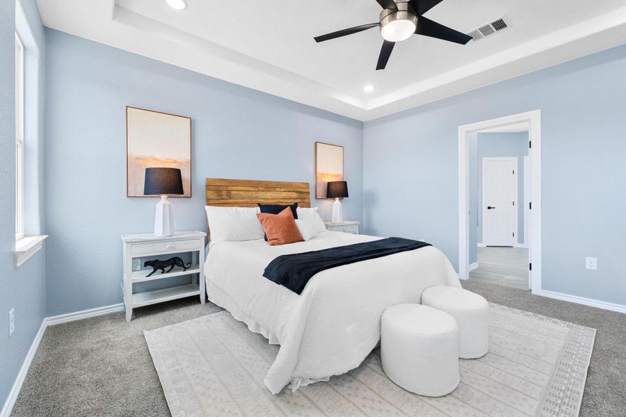 Bedroom featuring carpet floors, a raised ceiling, recessed lighting, and ceiling fan Bedroom featuring carpet floors, a raised ceiling, recessed lighting, and ceiling fan