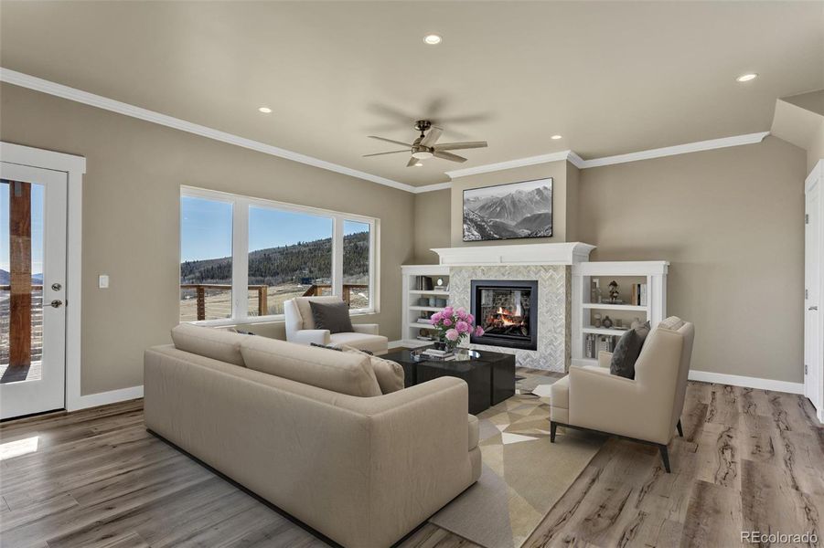 Relax in style by the designer gas fireplace, complete with a custom herringbone tile surround and built-in shelving, all while the majestic peaks serve as your living wallpaper. Relax in style by the designer gas fireplace, complete with a custom herringbone tile surround and built-in shelving, all while the majestic peaks serve as your living wallpaper.