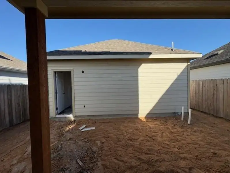 View of side of property with roof with shingles