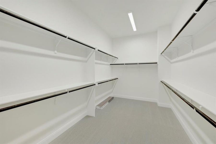 Walk in closet with light colored carpet Walk in closet with light colored carpet