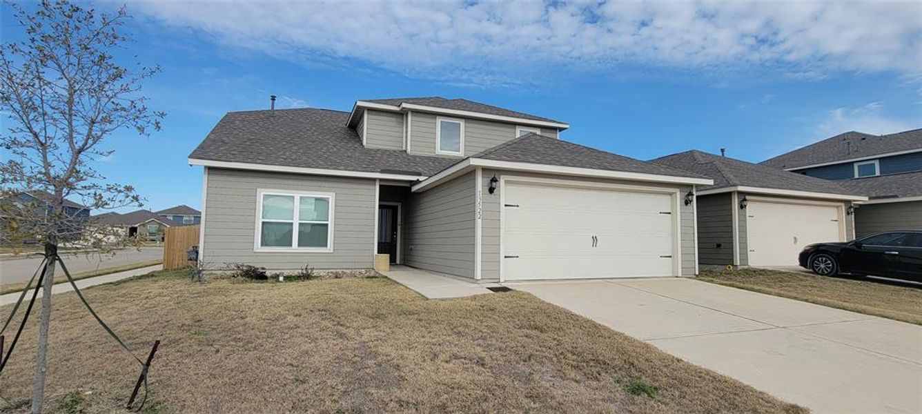 View of front of home featuring a garage and a front lawn