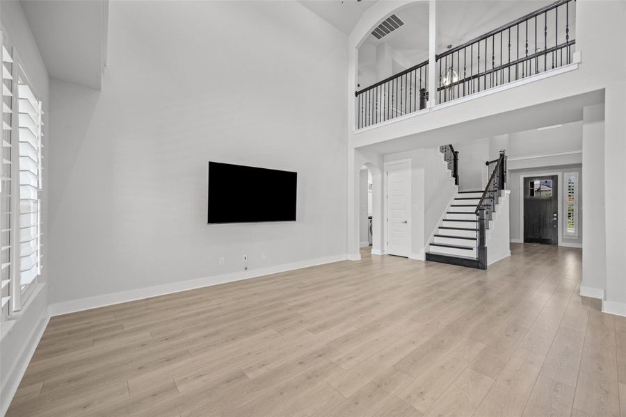 Grand two-story living area with high ceilings and an open-concept layout.
