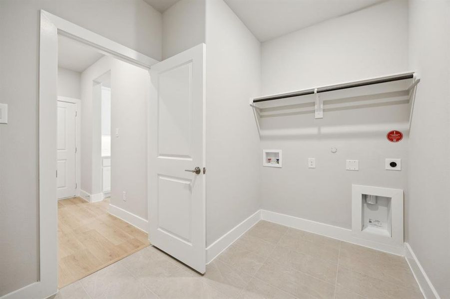 Washroom featuring gas dryer hookup, light tile patterned flooring, washer hookup, and electric dryer hookup