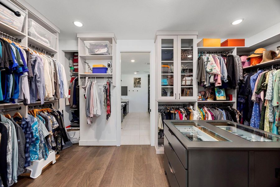 Primary walk in closet with built in island.