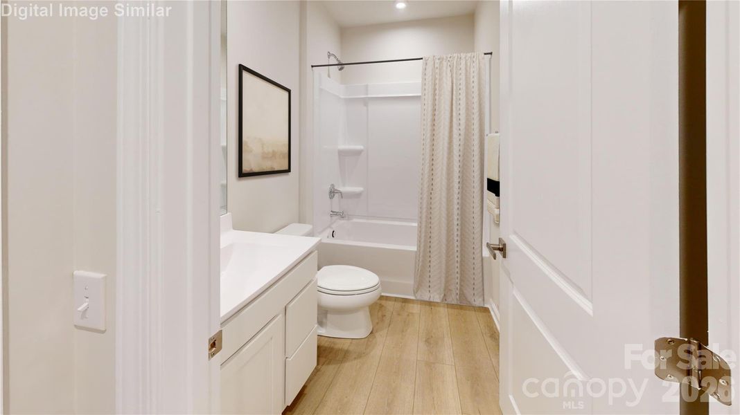 Upstairs bedroom featuring its own bath—offering comfort, convenience, and a touch of luxury for guests or family.