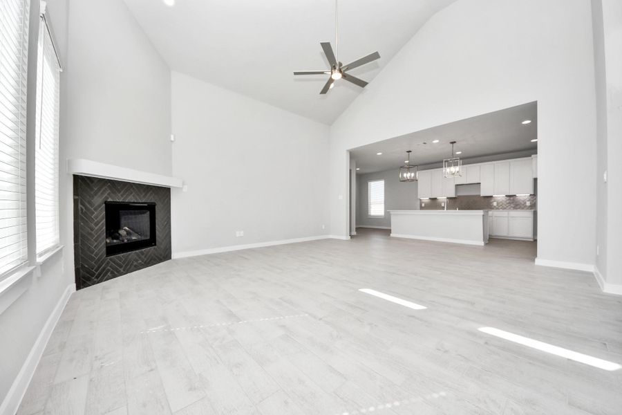 Take another glimpse into the heart of the home with this additional view of the family room—a sprawling space ready to accommodate all your gatherings. Sample photo of completed home with similar floor plan. Actual colors and selections may vary.