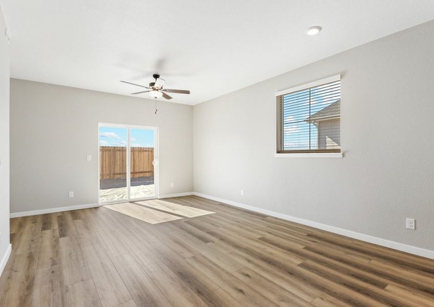 The family room is spacious with a ceiling fan!