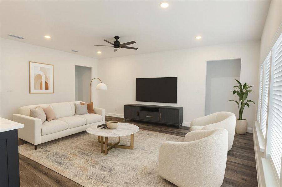 Living area with recessed lighting, a ceiling fan, and wood finished floors
