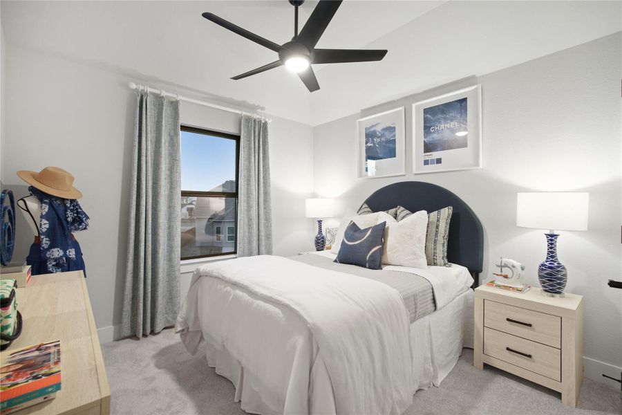 Bedroom featuring light colored carpet and a ceiling fan