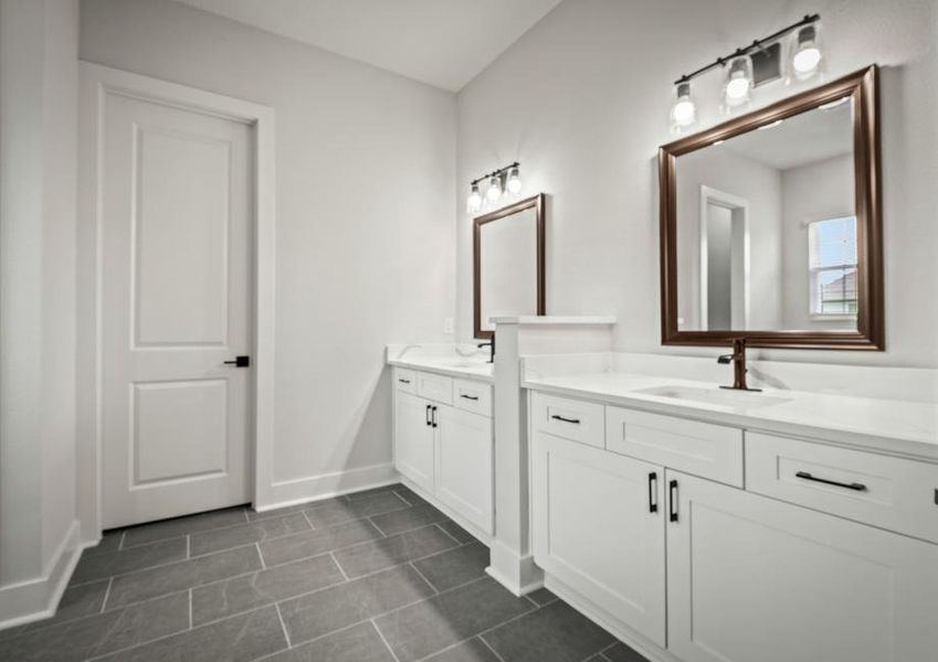 The master bathroom has a dual-sink vanity.