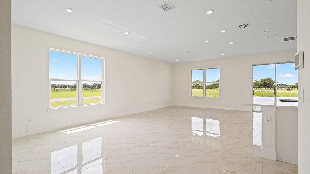 The Sweetgum Spacious and Bright Living Area in two story home in Trailside in Mount Dora by DRB Homes