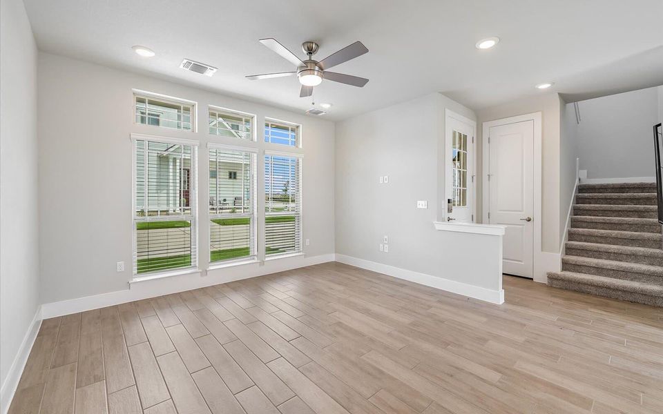Empty room with wood tiled floors, recessed lighting, and a ceiling fan Empty room with wood tiled floors, recessed lighting, and a ceiling fan