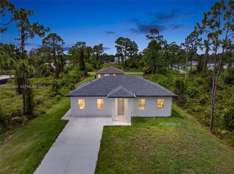 Front exterior of a new home in , Lehigh Acres, FL, highlighting curb appeal (Image 21).