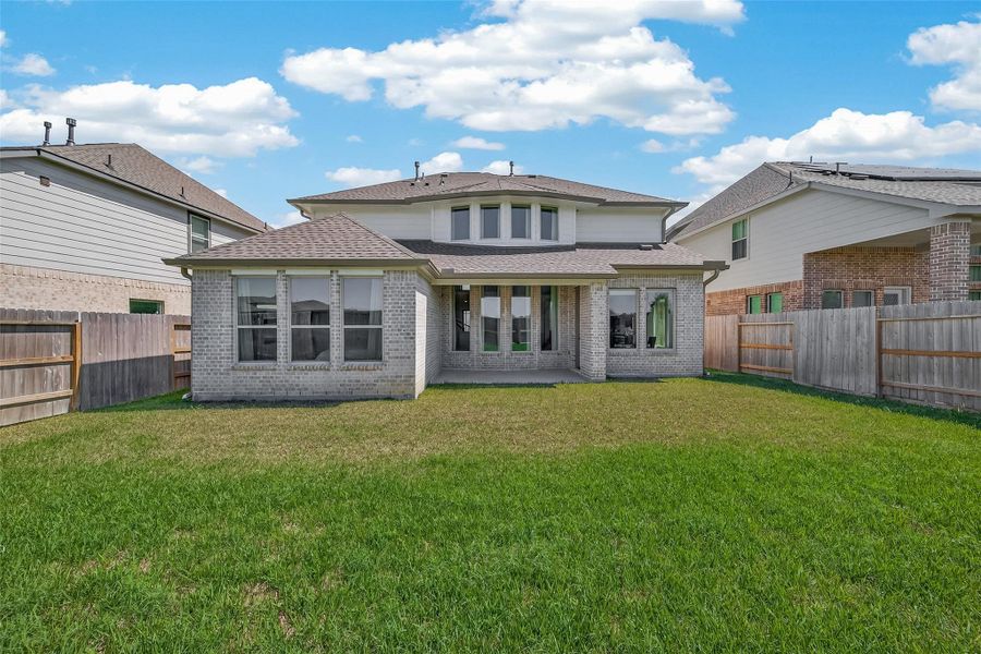 Spacious fenced backyard large with plenty of space for a swimming pool.
