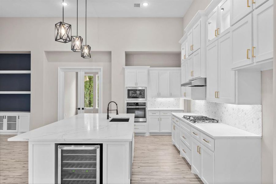 Bright modern style kitchen includes under-cabinet lighting, wine shelves  and wine fridge!