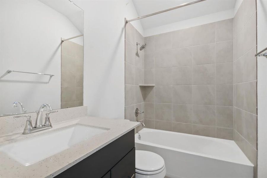 **REPRESENTATIVE IMAGE**•Secondary bathroom with seamless finishes featuring quartz countertops a uniquely designed tile on the floors and shower walls.