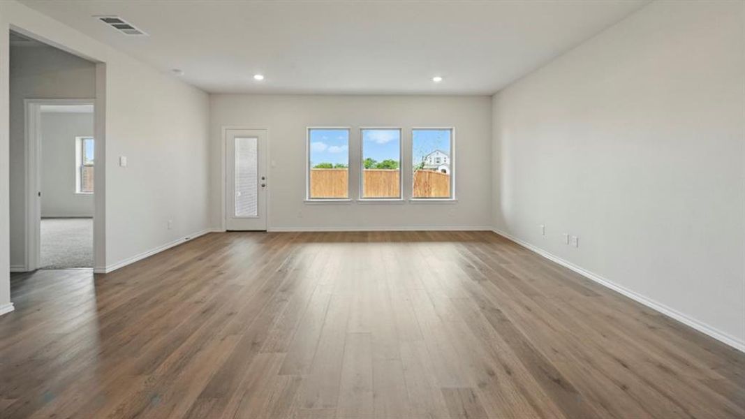 Unfurnished living room with wood finished floors and recessed lighting