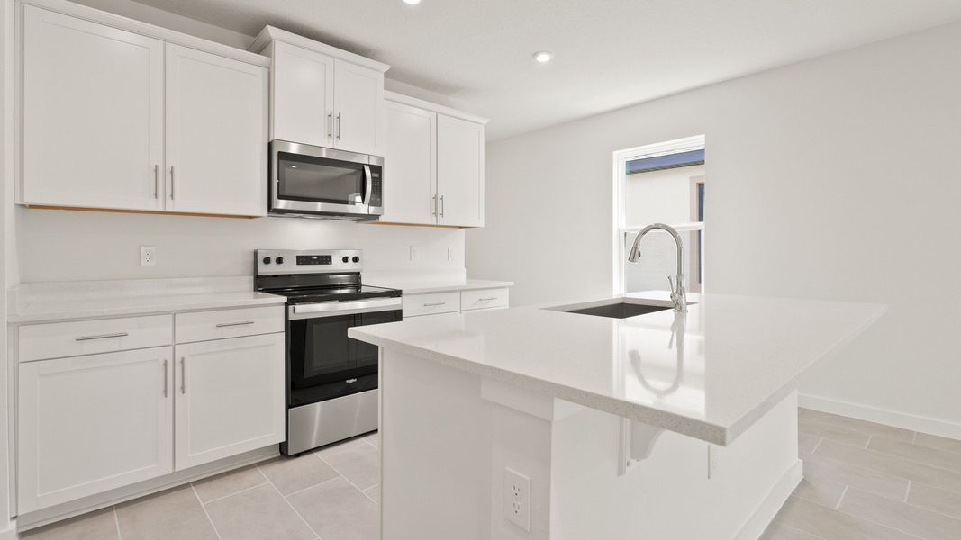 Bright Kitchen and Island in the Flager by DRB Homes in Hamilton Bluff. Bright Kitchen and Island in the Flager by DRB Homes in Hamilton Bluff.
