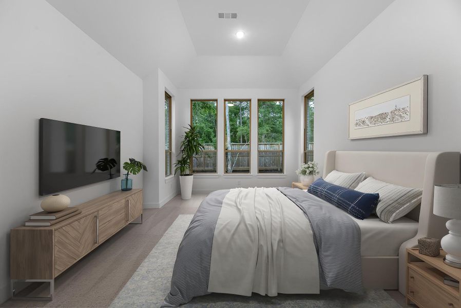 The primary retreat, virtually staged to show furniture placement, includes a sitting area and soaring ceilings. The primary retreat, virtually staged to show furniture placement, includes a sitting area and soaring ceilings.