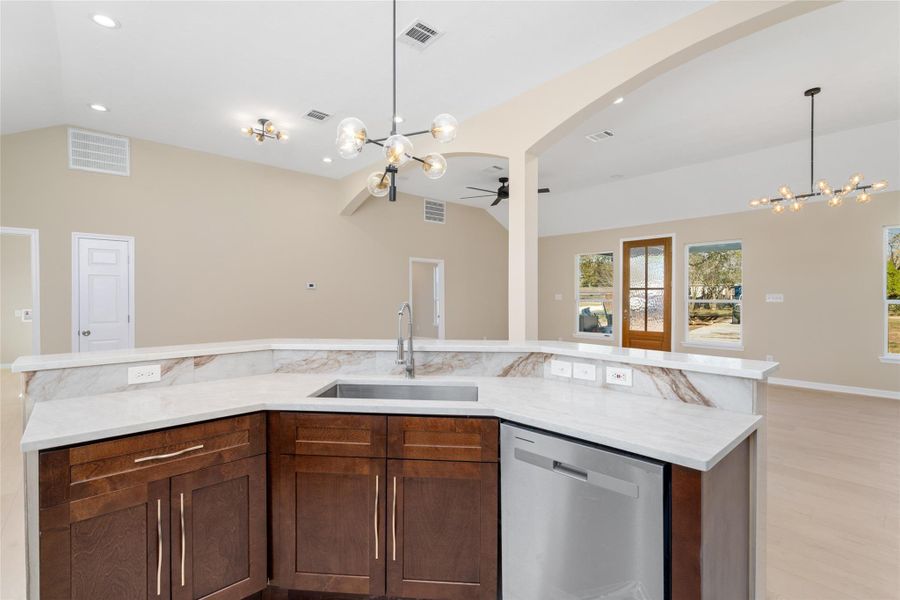 From this angle, the kitchenisland shines as thecenterpiece, ideal for mealprep, casual dining, orgathering with loved ones