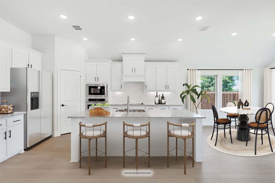Open kitchen with white cabinets, granite island with three bar stools, stainless appliances, and adjacent dining area with round table.