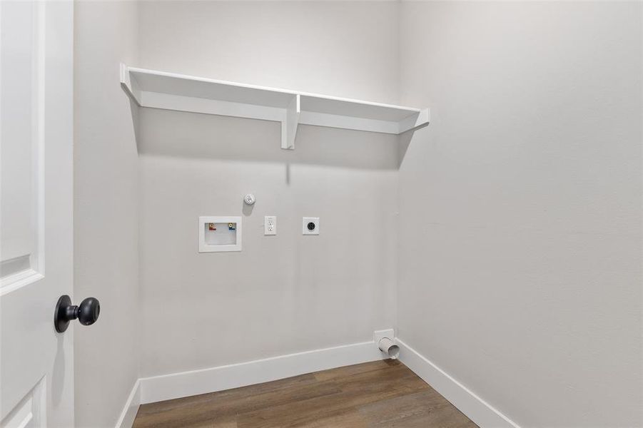 Clothes washing area featuring wood-type flooring, hookup for a washing machine, gas dryer hookup, and electric dryer hookup