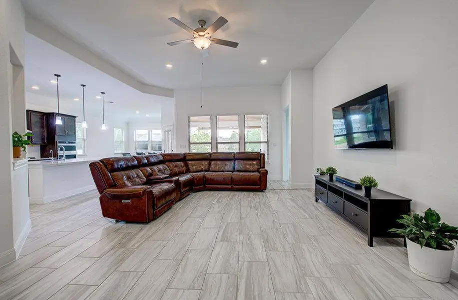 High ceilings and clean tile flooring define this airy open-concept living space. High ceilings and clean tile flooring define this airy open-concept living space.
