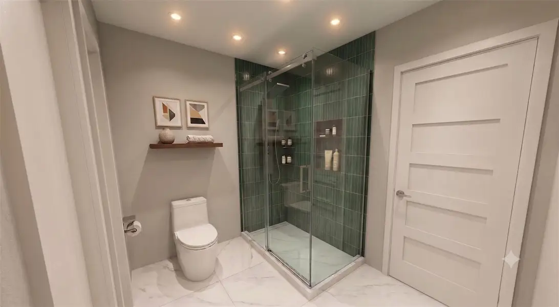 Gleaming marble tile floors pair beautifully with a glass-enclosed shower featuring vertical green tiling.