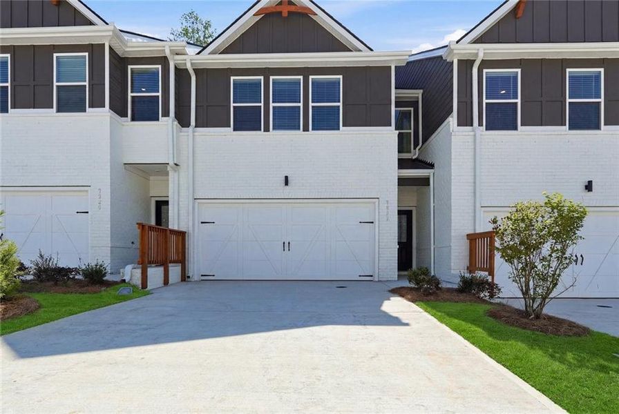 Front exterior of a new home in Concord Oaks, Powder Springs, GA, highlighting curb appeal (Image 1). Front exterior of a new home in Concord Oaks, Powder Springs, GA, highlighting curb appeal (Image 1).