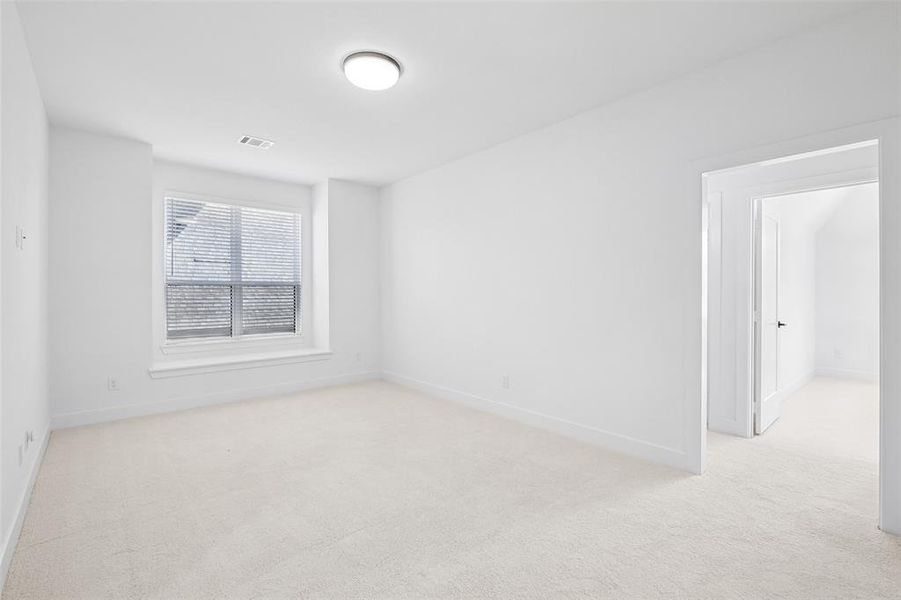 Unfurnished room with light colored carpet and baseboards Unfurnished room with light colored carpet and baseboards