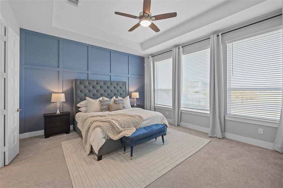 Large primary bedroom with accent wall