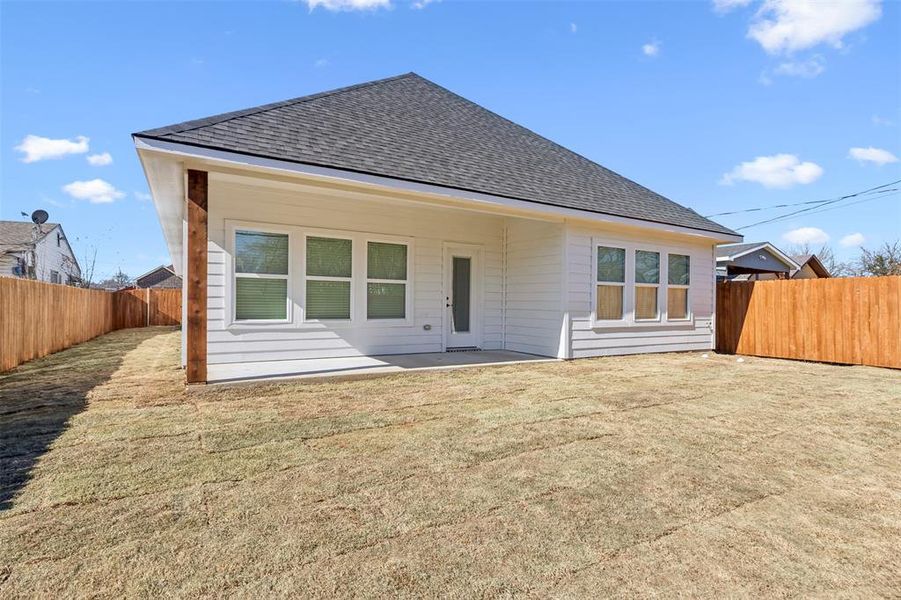 Back of house featuring a yard and a patio area