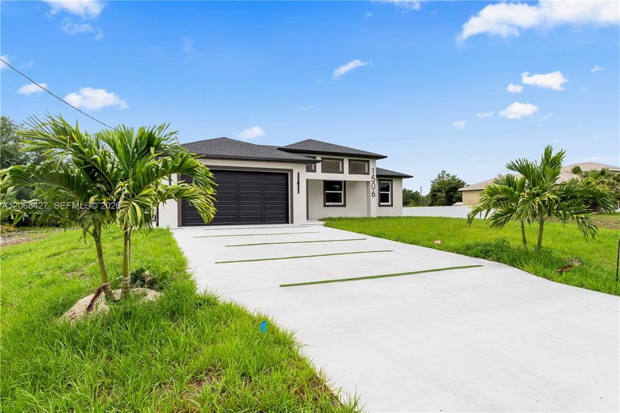 Front exterior of a new home in , Lehigh Acres, FL, highlighting curb appeal (Image 21). Front exterior of a new home in , Lehigh Acres, FL, highlighting curb appeal (Image 21).