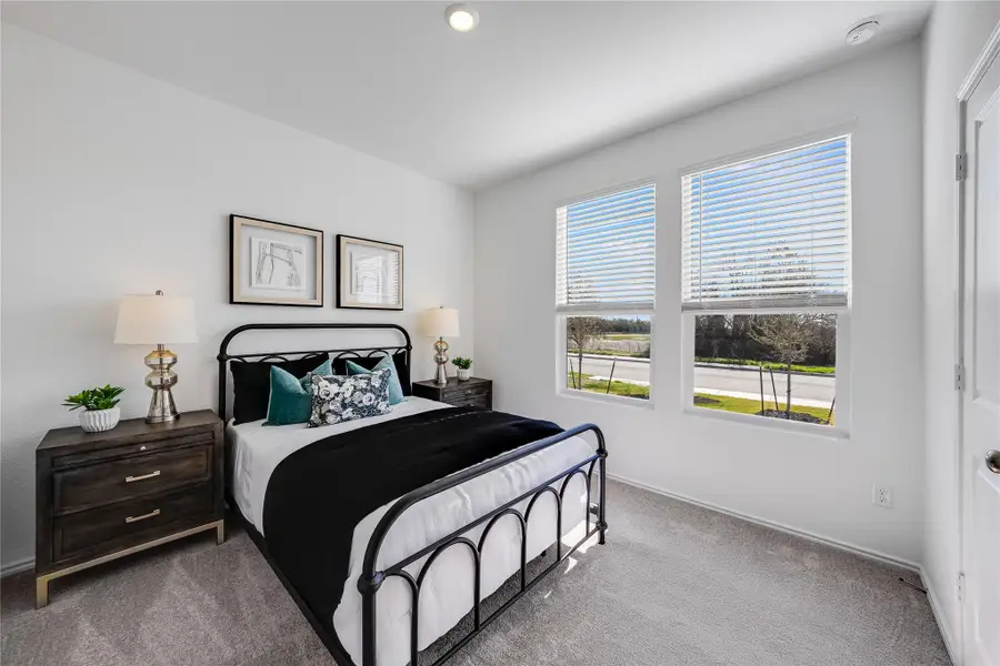 Bedroom featuring carpet flooring and baseboards