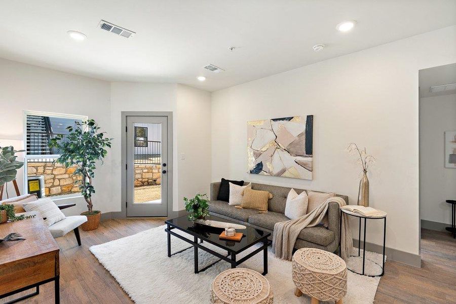 Living area featuring wood finished floors and recessed lighting