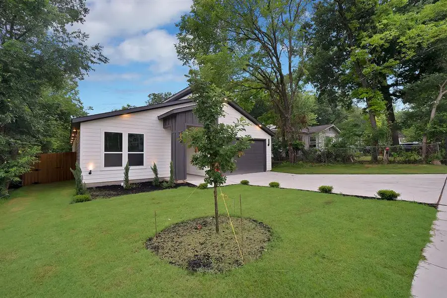 Contemporary single-story residence featuring a white horizontal siding facade and vertical dark gray accents Contemporary single-story residence featuring a white horizontal siding facade and vertical dark gray accents