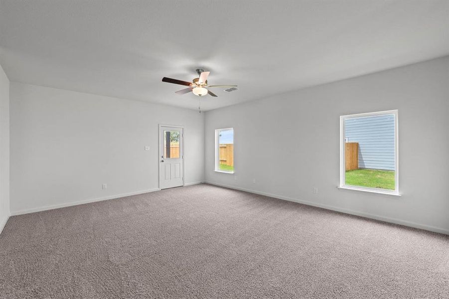 Living room featuring carpet flooring and ceiling fan