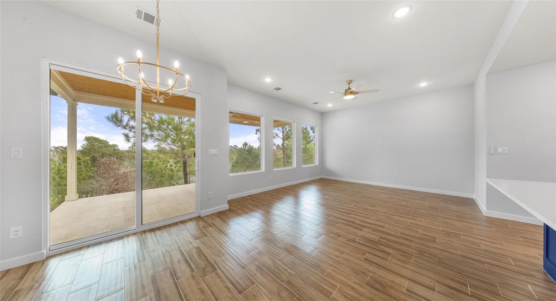 Unfurnished dining area featuring ceiling fan, light wood-style flooring, a chandelier, and recessed lighting