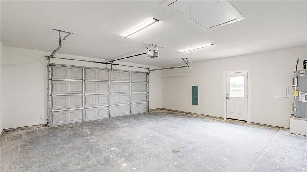 Oversized garage with door leading to the side yard. Smart App controlled garage door remote.